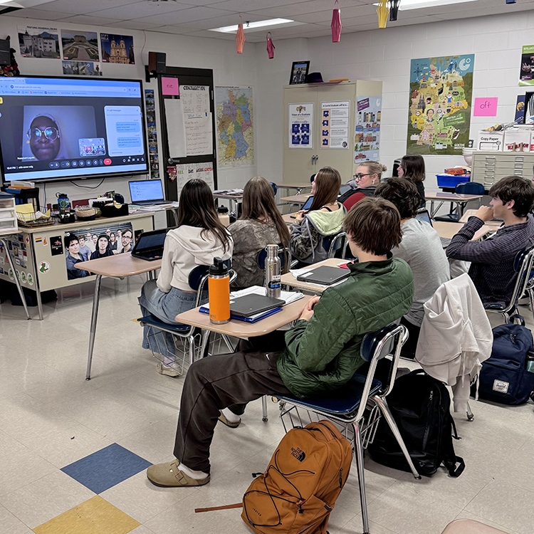 Students with a guest speaker on screen